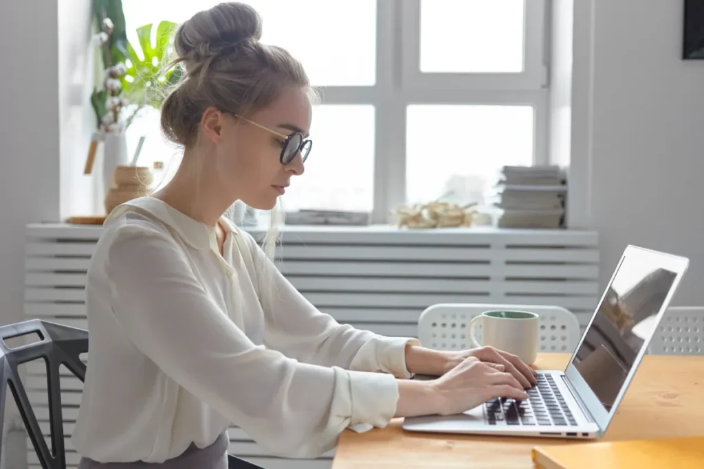 woman sitting at desk clicking through an email to shop