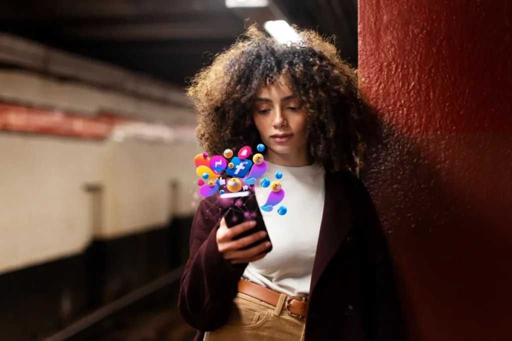 woman holding phone with social icons coming out of it