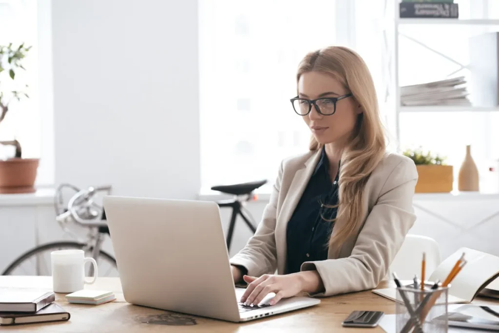 professional confident woman sitting at a computer working